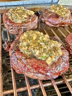 steaks cooking on top of an open grill