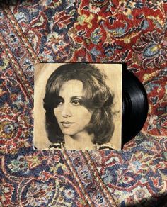 a black and white photo of a woman's face on top of a rug