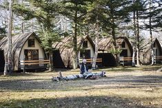 people are standing in front of small huts