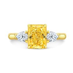 a yellow diamond ring with three diamonds on it