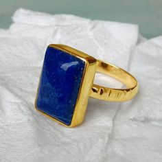 Lapis Lazuli gold ring, 14k yellow gold Lapis Lazuli ring, Lapis Lazuli jewelry,romantic gift, gold ring, gift for her, cushion lapis stone Lapis is known to activate the third eye chakra and is said to enhance intuition and psychic ability. Lapis is also said to help concentration, absorption and digestion of knowledge, and in teaching skills. The 14K yellow solid gold bezel and solid yellow gold ring are both shined to an extremely high polish. All rings are packaged and shipped in a beautiful ring box. The main stone is natural, shiny, Lapis Lazuli. Gemstone Size Approx : 14 x 10 mm The pictures have been enlarged to show the details. The price is for a 14k gold ring, if you want to order the ring in 18k or 22k gold please convo me prior to purchase. IMPORTANT NOTES This gold jewelry is Lapis Rings For Women, Yellow Gold Lapis Lazuli Gemstone Rings, Yellow Gold Rings With Lapis Lazuli Gemstone, Gold Rectangular Sapphire Ring For Anniversary, Gold Sapphire Ring With Rectangular Stone As Gift, Gold Rectangular Sapphire Anniversary Ring, Lapis Lazuli Gemstone Ring For Gift, Lapis Lazuli Gemstone Rings As Gift, Elegant Lapis Lazuli Ring With Polished Finish