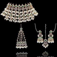 Delve into the mesmerizing and ethereal ensemble curated especially for your big day! Charming set beautifully laced with emerald stones, depicting the sparkle of a thousand stars with CZ stone and inheriting classic grace with white pearl detailing. The set includes a necklace a matching maang teekah, a jhoomar/passa and a pair of beautiful jhumkey earrings with saharay. Approximate earrings length is 3". Please click on the video for a detailed view of the product. Designed over high-quality b Elegant Green Celebration Sets, Elegant White Pearl Sets, Elegant Pearl Bridal Sets For Reception, Elegant Pearl Sets With Stone Work, Elegant Emerald Jewelry Sets With Stone Work, Green Pearl Bridal Necklace For Wedding, Emerald Jewel Bridal Necklace For Wedding, Exquisite Green Bridal Necklace For Wedding, Elegant Green Bridal Set For Wedding