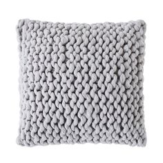 a gray knitted pillow on a white background