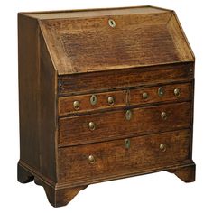 an old wooden desk with drawers and knobs