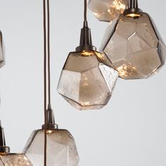 three glass lights hanging from a ceiling