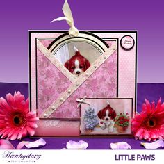 a card with a little dog in it and pink flowers on the bottom right side