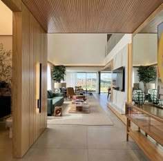 a large living room with wood paneling and glass doors leading to an outside patio