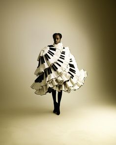 a woman in a dress made out of piano keys