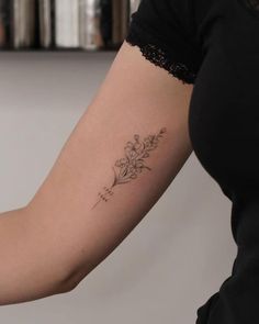 a woman with a flower tattoo on her arm