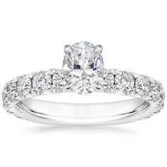 Oval Shaped Luxe Ellora Diamond Engagement Ring - Platinum. This classic engagement ring features sparkling diamond accents that extend three-fourths of the way around the ring. A diamond adorned gallery and graceful claw prongs embrace the center gem (1 2/5 total carat weight). Oval Diamond Ring With Side Stones In White Gold, Oval White Gold Diamond Ring With Side Stones, Formal Oval Diamond Ring With Side Stones, Elegant Oval Diamond Ring With Side Stones, Formal Oval Wedding Ring With Side Stones, Oval Diamond Ring With Side Stones, Fine Jewelry, Oval Diamond Ring With Side Stones For Wedding, Oval Diamond Wedding Ring With Side Stones, White Wedding Rings With Side Stones