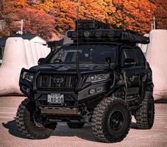 a black four door suv parked in a parking lot