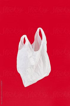 a white plastic bag on a red background