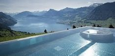 an empty swimming pool with mountains in the background