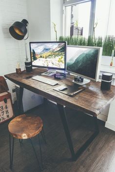 a computer desk with two monitors on it