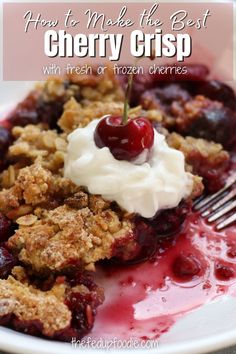 a white plate topped with fruit covered crumbles and whipped cream on top of it