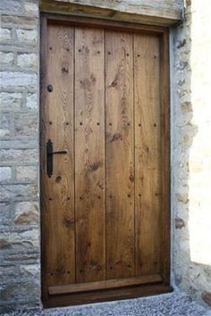 a wooden door in front of a stone building