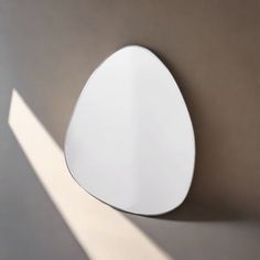 a white mirror mounted to the side of a wall