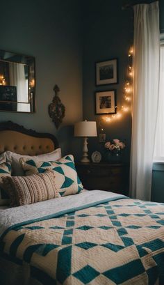 a bed sitting next to a window with lights on the wall above it and a night stand