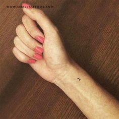 a woman's hand with a small tattoo on it, and the word love is written