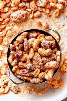 a bowl filled with nuts sitting on top of a table