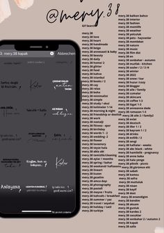 a cell phone sitting on top of a table next to an array of writing and numbers