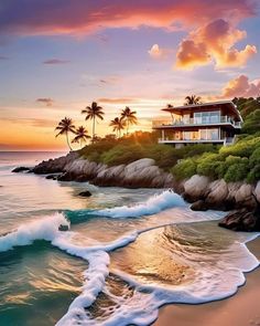 a house on top of a hill next to the ocean with waves crashing in front of it