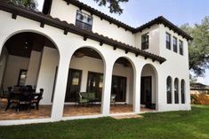 a large white house with arches around it