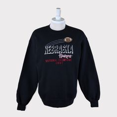 Embroidered Vintage 1997 National Champions Nebraska Cornhuskers (University of Nebraska-Lincoln) Football/Basketball NCAA Sweatshirt 💯 SATISFACTION AND AUTHENTICITY ⭐ MEASUREMENTS (when laid flat) Size on Tag: L Length: 71cm or 28 inches Armpit to armpit: 58cm or 23 inches ⭐ CONDITION 9/10 (Very good) Details: No holes Material: Cotton Color: Black Brand: NAS 🔷 Please give us your phone no. together with address after you purchased. 🔷Please keep in mind that our items are vintage so they may Throwback Long Sleeve T-shirt For College, College Fan Apparel Crew Hoodie, College Crew Neck Fan Apparel Hoodie, College Crew Hoodie In Fan Apparel Style, Varsity Crew Neck Hoodie For College, College Sports Season Crew Neck Hoodie, Sports Season Embroidered Sweatshirt For Streetwear, Collegiate Crew Neck Hoodie For Sports Season, Embroidered Graphics Sweatshirt For Sports Season Streetwear