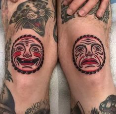 two men with tattoos on their legs, one has a clown face and the other has a cat's head