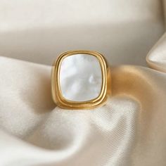 The Pearl Signet Ring combines classic design with a modern twist. Featuring a lustrous pearl set in an 18k gold-plated signet, this ring adds a touch of timeless sophistication and elegance to any outfit. Chic Polished Finish Formal Ring, Modern Gold Pearl Ring For Everyday, Modern Everyday Gold Pearl Ring, Elegant Gold Pearl Ring For Everyday, Elegant Everyday Gold Pearl Ring, Chic Formal Jewelry Ring, Elegant Tarnish Resistant Dome Ring, Classic Gold-plated Pearl Ring, Elegant Gold Plated Dome Ring With Polished Finish