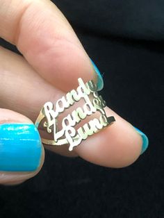 a woman's hand holding a ring with the words randy and lynn on it