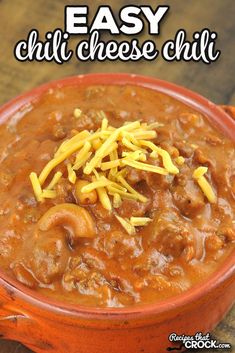 an orange bowl filled with chili cheese and pasta on top of a wooden table in front of the words easy chili cheese chili