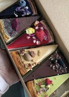 a box filled with lots of different types of desserts on top of each other