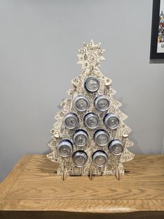 a christmas tree made out of cans on top of a wooden table