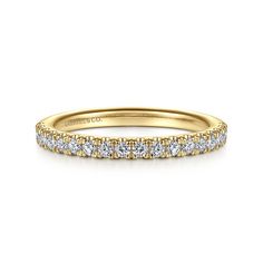 a yellow gold wedding band with rows of diamonds