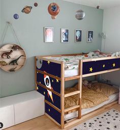 a child's bedroom with a bunk bed and space themed decor