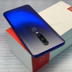 the oneplus phone is sitting on top of a box