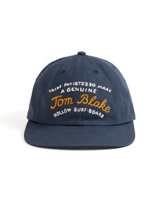 This hat graphic was inspired by Tom Blake's patented trademark for the construction plans of his original design for the Hollow Surfboard from 1926.