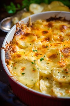 a casserole dish filled with potatoes and cheese