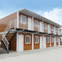 a two story building with stairs leading up to the second floor and another unit below