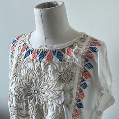 Nwt Beautiful Johnny Was Embroidered Cap Sleeve Top. Ivory (Jw Color States “Natural”) Background With Multi Colored Embroidered Florals And Geometric Designs. Please See Close Up Pictures For All The Fabulous Details With Metallic And Soft Playful Colors. This Top Has Small Pockets In The Front (Also Pictured Close Up) And A Raw Edge Cool Neck Detail. Easy To Dress Up Or Down!! This Is A Forever Classic Piece With Its Incredible Detailing!! White Bohemian Embroidered Top For Summer, White Bohemian Top With Tonal Embroidery, White Bohemian Tops With Tonal Embroidery, White Geometric Embroidered Short Sleeve Top, Summer Embellished Multicolor Embroidered Top, Embroidered Cream Top For Festival, White Top With Geometric Embroidery For Vacation, White Embroidered Top With Geometric Embroidery And Short Sleeves, Embroidered Cream Tops For Festival