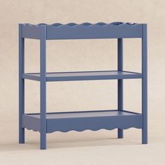 a blue shelf with scalloped shelves on it's sides, against a beige background