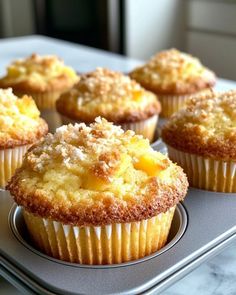 several muffins sitting on top of a metal pan