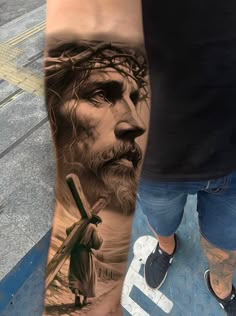 a man with a jesus tattoo on his leg