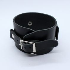 Johnny Depp style wide leather watchband adjustable by single buckle. This bracelet can be use as a wrist tattoo cover, besides it's suitable for most existing wristwatches. Before buy please measure your watch in 2 dimensions (see last picture in listing) and choose lug size you need. Between keepers we can add hole with diameter 20 or 26 mm for smart watch works right. To find other colors - check our items ( we will add new photos soon), on the photo - glossy black color. Suitable for standar Black Leather Wristband With Bracelet Strap, Modern Black Leather Strap Wristband, Black Leather Bracelet With Wrist Strap, Adjustable Black Leather Strap Cuff Bracelet, Classic Black Bracelets With Wrist Strap, Classic Black Bracelet With Wrist Strap, Adjustable Black Watch Band With Wrist Strap, Adjustable Black Wrist Strap Watch Accessories, Black Adjustable Wrist Strap For Watch