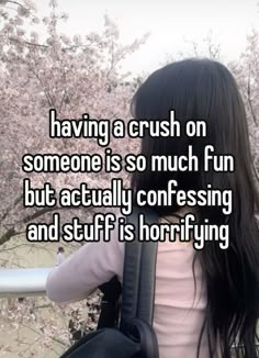 a girl with long black hair standing in front of a tree and text saying having a crush on someone is so much fun but actually confusing and stuff