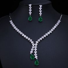 Make a stunning statement with this exquisite jewelry set, featuring a captivating emerald green cubic zircon necklace and earrings. Whether you're attending a wedding, a special event, or simply want to add a touch of sophistication to your ensemble, this set is the perfect choice. Key Features: Designed for the trend-conscious individual Elegant geometric shape and pattern Suitable for weddings and other special occasions Made of high-quality copper and adorned with shimmering cubic zirconia I Green Sparkling Stones Jewelry Sets For Party, Green Crystal Jewelry Sets With Sparkling Stones, Formal Green Cubic Zirconia Emerald Necklace, Green Cubic Zirconia Necklace For Parties, Green Cubic Zirconia Party Necklace, Green Formal Jewelry With Sparkling Stones, Green Sparkling Stones Jewelry For Formal Occasions, Green Crystal Jewelry Sets For Formal Occasions, Green Sparkling Stones Formal Jewelry