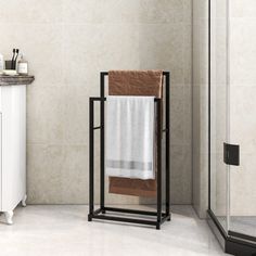 a towel rack in the corner of a bathroom