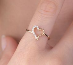 Our open heart ring is 14k solid gold. Its half of the heart is decorated with charming zircon stones. Our gold ring has a dainty style that can fit your all outfit. Our hollow heart ring makes happy your loved ones. It will be a perfect gift for valentine's day, mother's day, graduations, anniversaries, or birthdays. 🎁 If you want, you can add a gift note for your loved ones. It arrives in a special jewelry gift box. ✨ We respond to your questions happily. Your question will be answered within Valentine's Day Dainty Heart Ring With Diamond Accents, Gold Heart-shaped Diamond Ring For Proposal, Gift Heart Ring With Diamond Accents, Heart Shaped Ring With Diamond Accents As Gift, Valentine's Day Diamond Heart Open Ring, Yellow Gold Open Heart Wedding Ring, Dainty Open Heart Ring For Anniversary, Heart-shaped Yellow Gold Diamond Ring For Proposal, Dainty Open Heart Wedding Ring