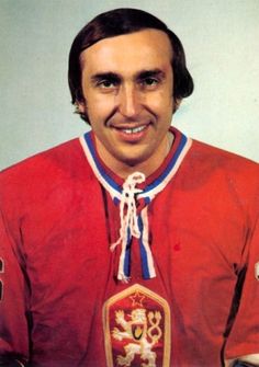 a man wearing a red jersey with a blue and white ribbon around his neck